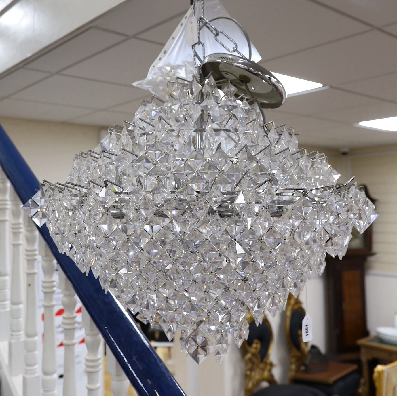 A ten tier, eighteen light, graduated chrome chandelier, with diamond shaped clear perspex drops